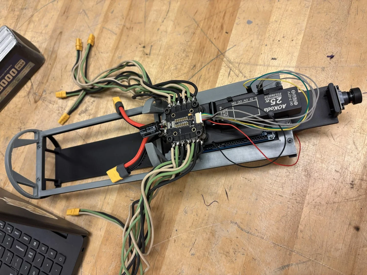 N3M0's internal electronics tray with boards, power components, and wiring laid out on the workbench